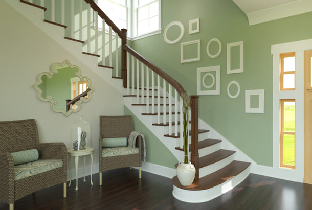 Open below staircase with curved starter tread and stained wood railing.