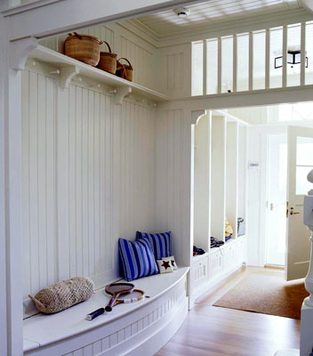 An entry way with beaded-board paneling backing a small bench