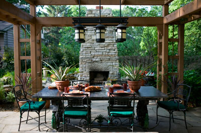 An outdoor dining room under a wooden pergola