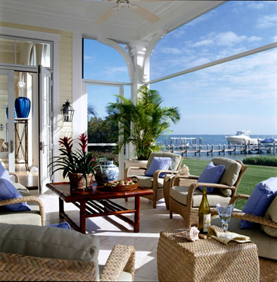 A sunlit screened in porch on the water