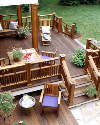 A stained deck with adirondack chairs