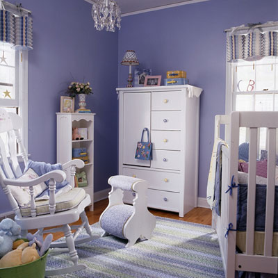 A purple themed nursery with white color accents