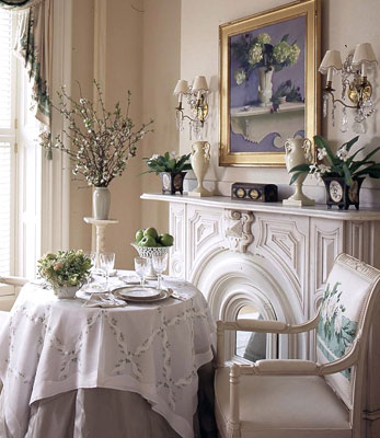 A table and place-setting next to a closed-off fireplace