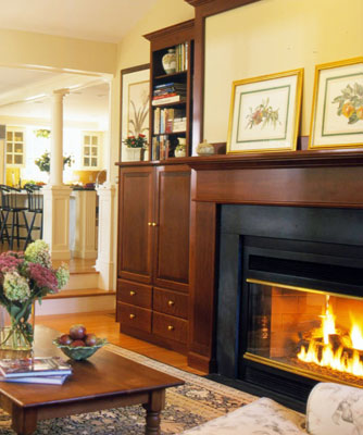 Inset fireplace with pictures over the mantel