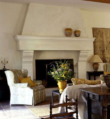 A living room fireplace with several couches and chairs around it