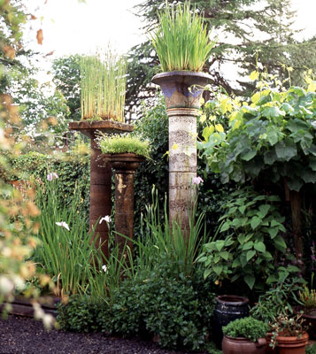 Mutli-height pillars with plants growing on top of each one