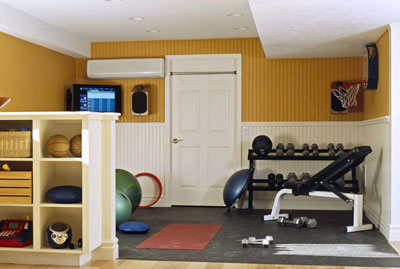 A small weight room with a weight set