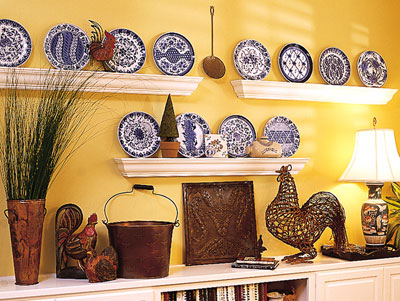 Shelves with crown-molding on them holing up several styles of plates
