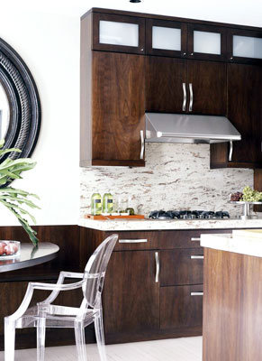 A kitchen with modern dark wood cabinets