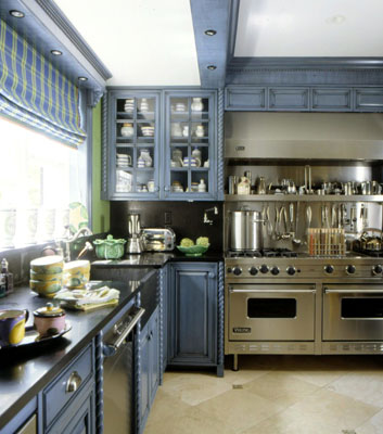 A modern kitchen with dark cabinets and a stainless steel stove and oven