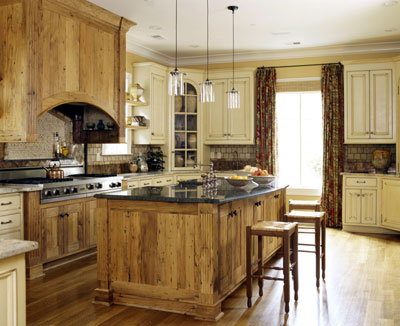 A rustic kitchen with wood style cabinets and wood floors