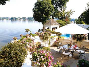 Patio on the water surrounded by plants