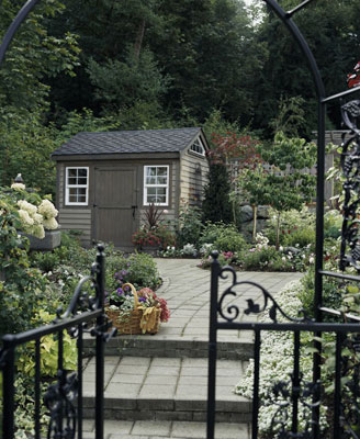 A stone path and stairs to a small cottage house