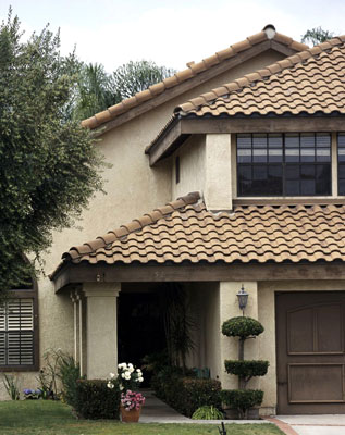 House with a hip roof style and clay shingles