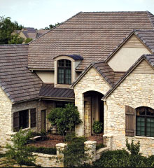 A stone venere house with several different roof styles