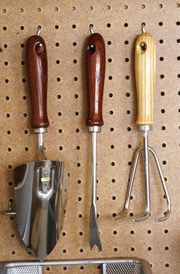 Garden hand tools hanging on the wall