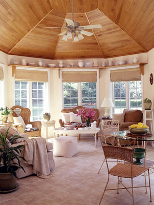 An open room with floor to ceiling windows and several chairs