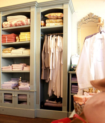 A closet with custom moldings for all of the shelving