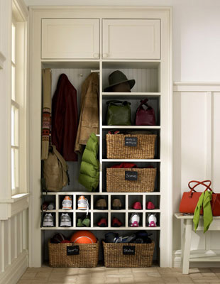 A closet built into a mud room to hold everyone's things